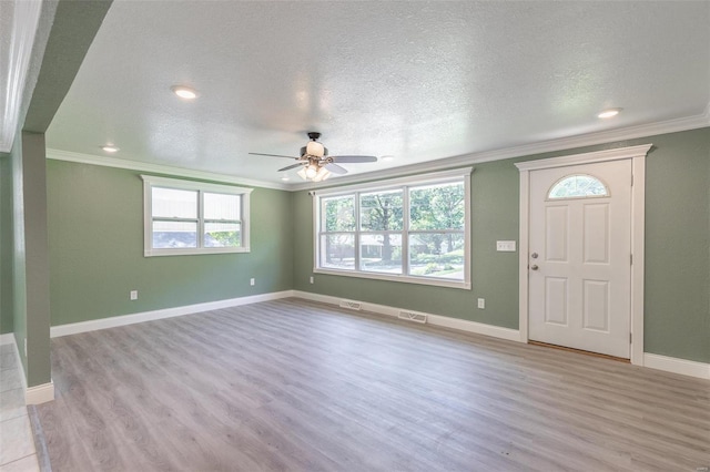 foyer featuring a textured ceiling, crown molding, ceiling fan, and light hardwood / wood-style flooring