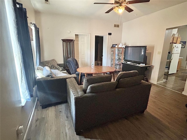 living room featuring hardwood / wood-style flooring and ceiling fan