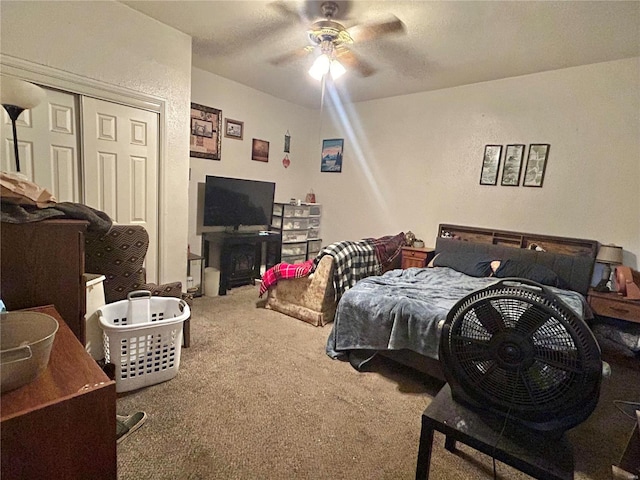 bedroom with ceiling fan, a closet, and carpet