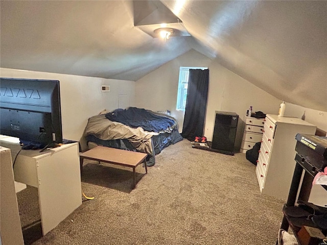 bedroom featuring lofted ceiling and carpet floors