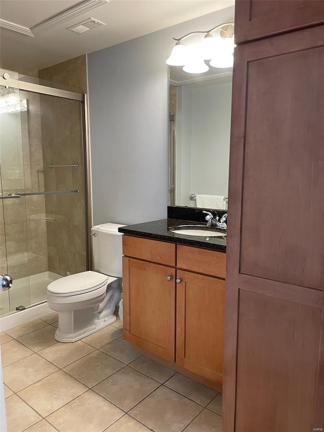 bathroom with ornamental molding, tile patterned floors, vanity, toilet, and walk in shower