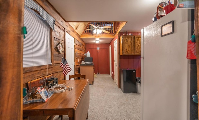 interior space featuring wood walls and light carpet