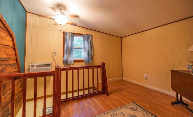 interior space with ceiling fan, vaulted ceiling, and light hardwood / wood-style floors