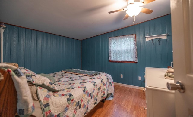 bedroom featuring ceiling fan, lofted ceiling, and hardwood / wood-style floors