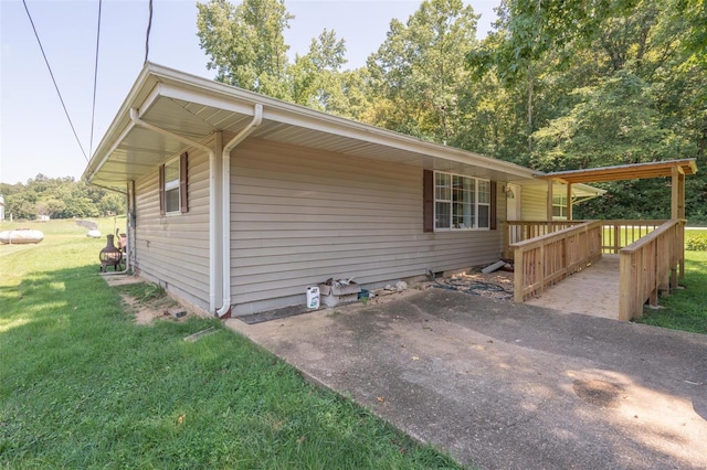 view of side of home with a yard