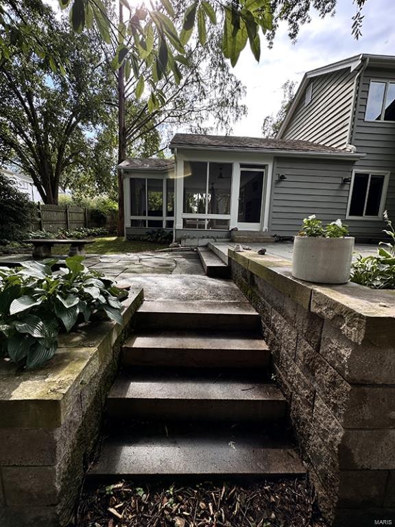 exterior space featuring a patio area, a sunroom, and french doors