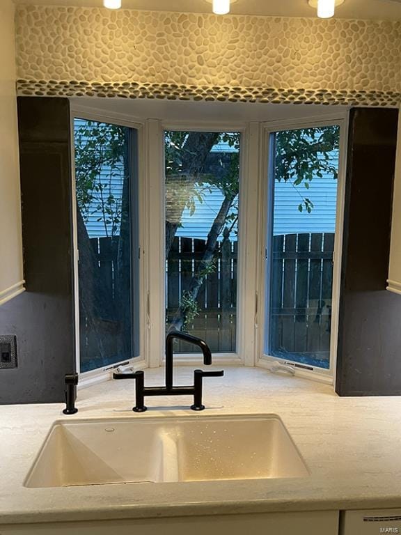 interior space with sink and light stone countertops