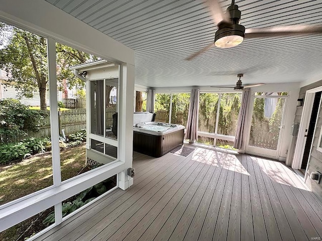 unfurnished sunroom with ceiling fan