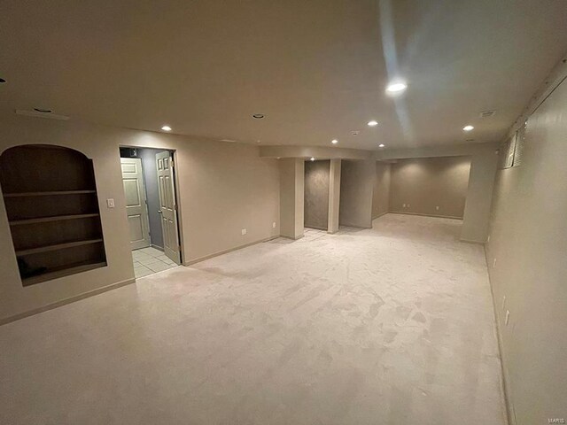 basement featuring light carpet