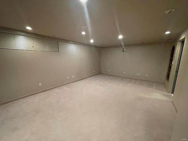 basement featuring light carpet