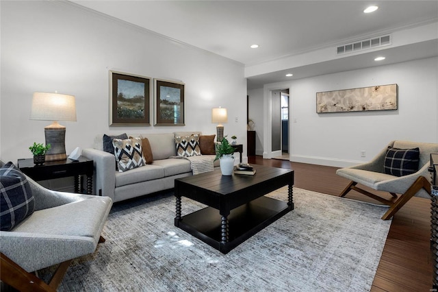 living room with recessed lighting, visible vents, baseboards, ornamental molding, and dark wood-style floors