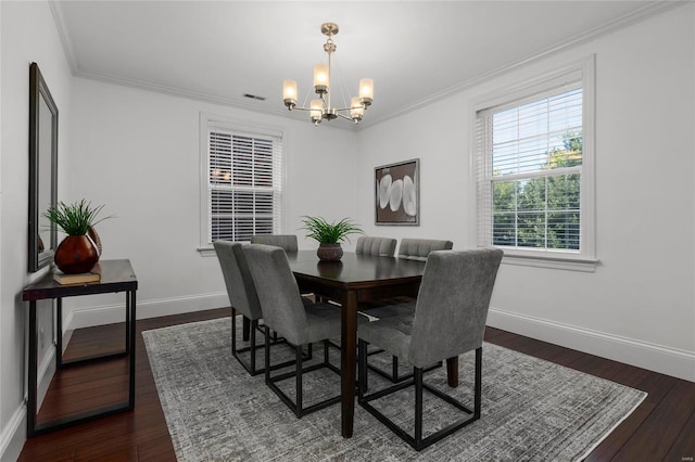 dining room featuring baseboards, visible vents, dark wood finished floors, ornamental molding, and a chandelier