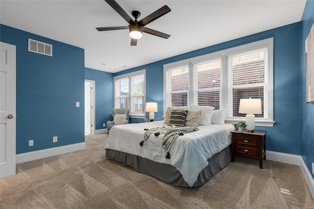 carpeted bedroom with ceiling fan, visible vents, and baseboards