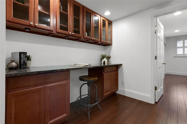 bar with dark wood-style flooring, recessed lighting, and baseboards