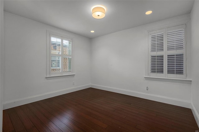 unfurnished room with baseboards, dark wood-style flooring, and recessed lighting