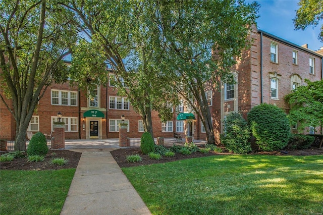 view of front of property with brick siding and a front yard