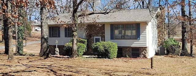 view of front of house with stone siding and cooling unit