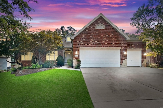 view of property with a lawn and a garage