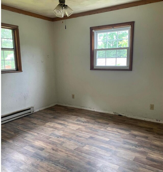 empty room with a baseboard radiator, hardwood / wood-style flooring, ornamental molding, and ceiling fan