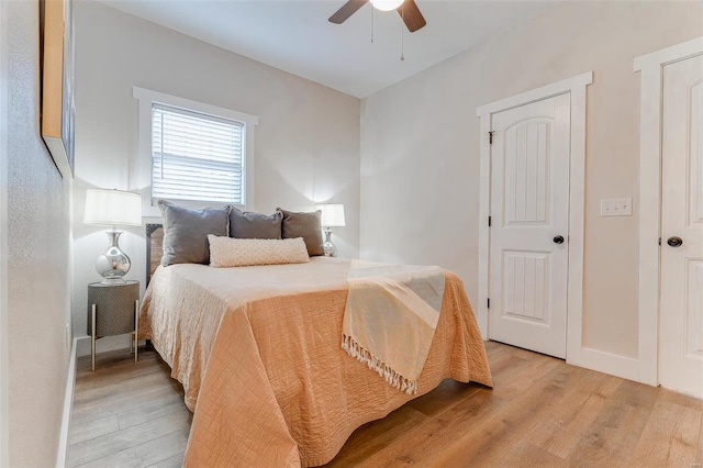 bedroom with ceiling fan and light hardwood / wood-style floors