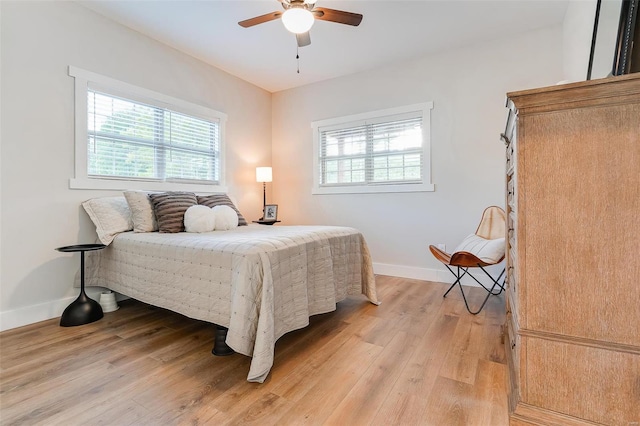 bedroom with light wood-type flooring and ceiling fan