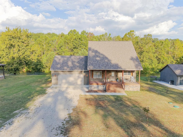 view of front of house featuring a garage, a front yard, and a porch