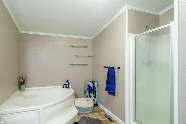 bathroom featuring hardwood / wood-style flooring, ornamental molding, and separate shower and tub