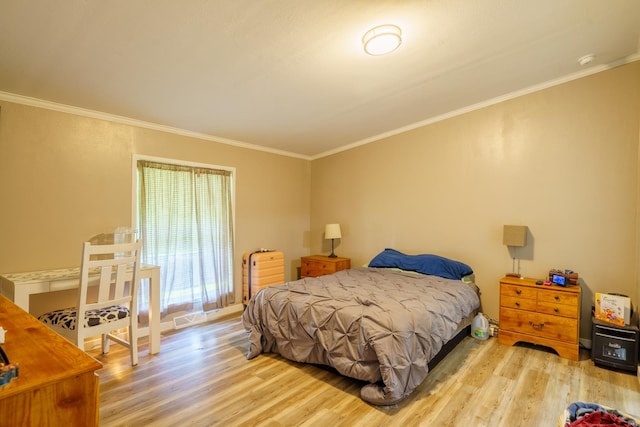 bedroom featuring crown molding and light hardwood / wood-style flooring