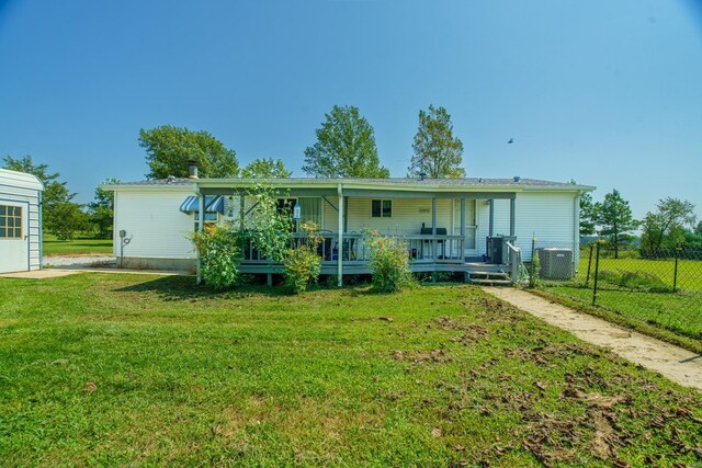 view of front of property featuring central AC unit, a porch, and a front yard