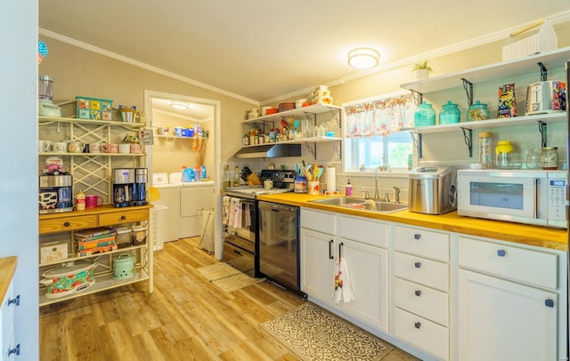 kitchen featuring open shelves, white microwave, independent washer and dryer, and butcher block counters