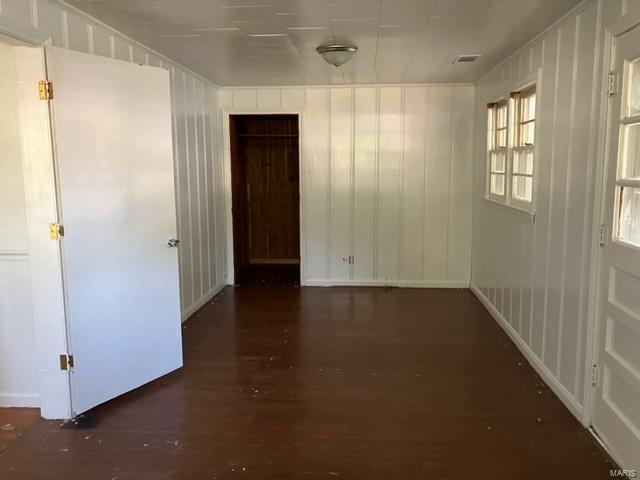 unfurnished room with wood-type flooring