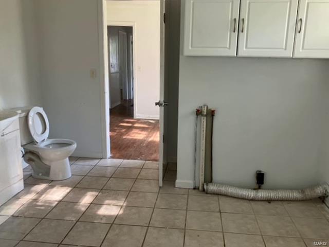 bathroom with toilet and tile patterned floors