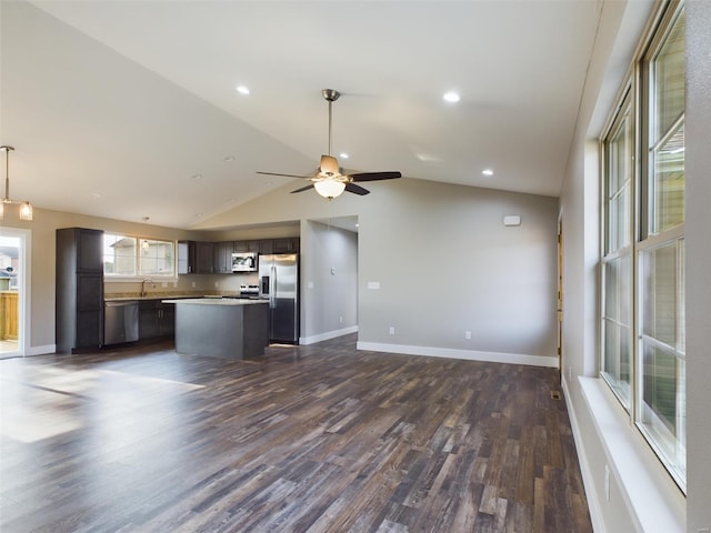 kitchen featuring appliances with stainless steel finishes, dark brown cabinetry, dark hardwood / wood-style floors, ceiling fan, and lofted ceiling