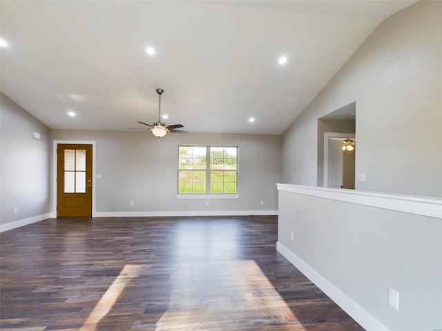 interior space with ceiling fan, vaulted ceiling, and dark hardwood / wood-style flooring