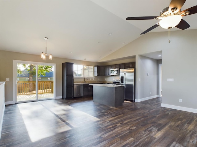 kitchen with ceiling fan, dark hardwood / wood-style floors, appliances with stainless steel finishes, a center island, and dark brown cabinets