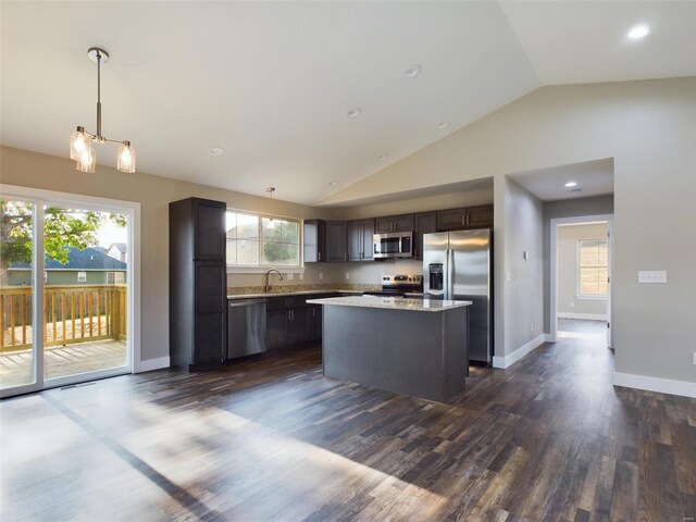 kitchen with a kitchen island, decorative light fixtures, stainless steel appliances, dark hardwood / wood-style flooring, and dark brown cabinets