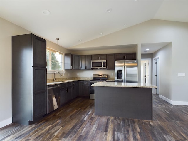 kitchen with a kitchen island, dark hardwood / wood-style flooring, vaulted ceiling, sink, and stainless steel appliances