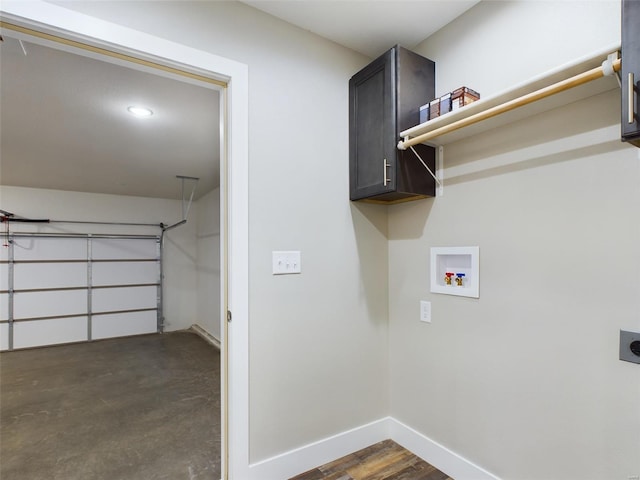 washroom featuring dark wood-type flooring, cabinets, hookup for a washing machine, and hookup for an electric dryer