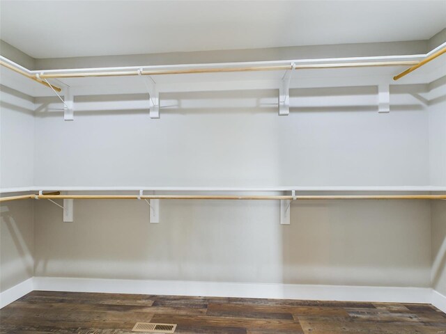 walk in closet featuring dark wood-type flooring