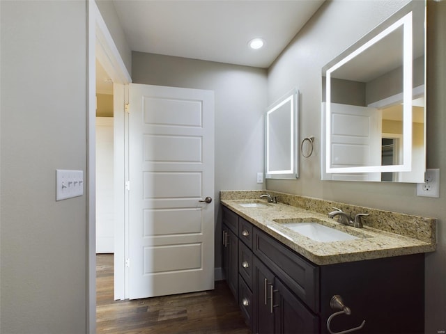 bathroom with double sink vanity and wood-type flooring