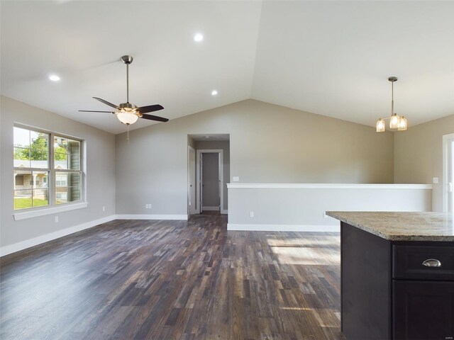 interior space with dark hardwood / wood-style flooring, ceiling fan with notable chandelier, and lofted ceiling