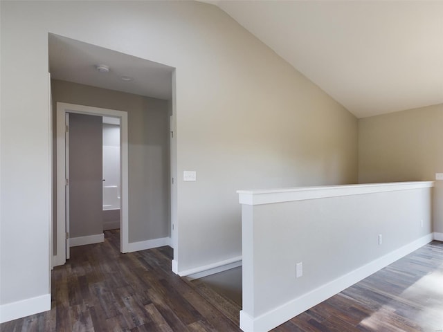 empty room with hardwood / wood-style floors and lofted ceiling