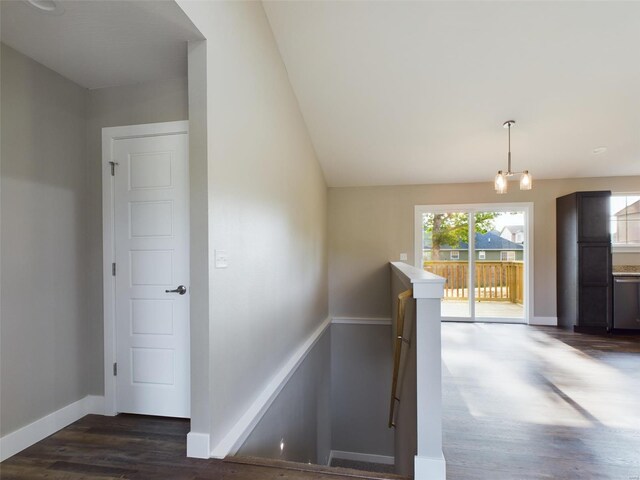 staircase with wood-type flooring and lofted ceiling