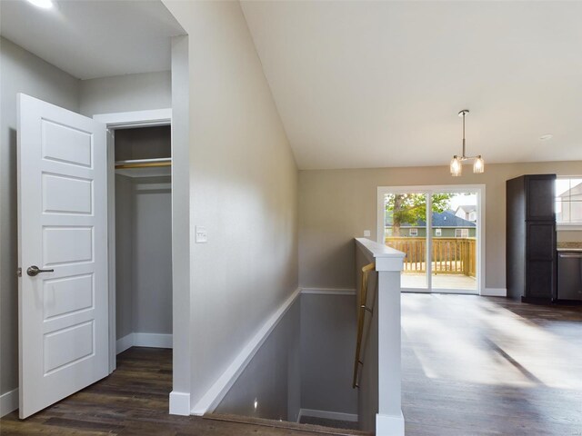 staircase with vaulted ceiling and wood-type flooring