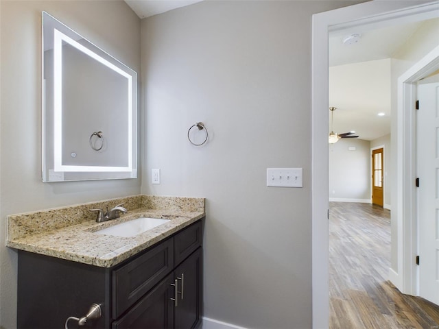 bathroom featuring ceiling fan, vanity, and hardwood / wood-style floors