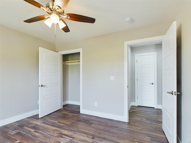 unfurnished bedroom featuring ceiling fan, a closet, and dark wood-type flooring