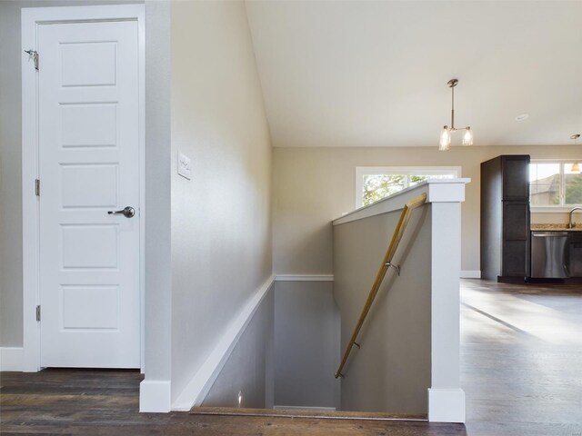 stairs with vaulted ceiling, hardwood / wood-style floors, and a healthy amount of sunlight