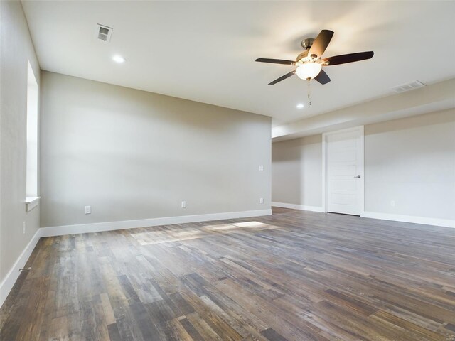 spare room with ceiling fan and dark wood-type flooring