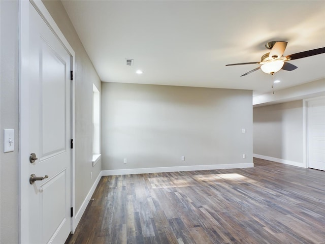 empty room with ceiling fan and dark hardwood / wood-style floors