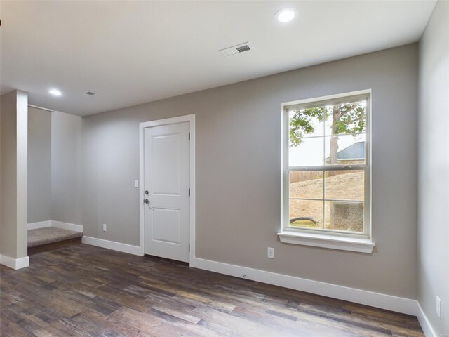 spare room with dark hardwood / wood-style floors